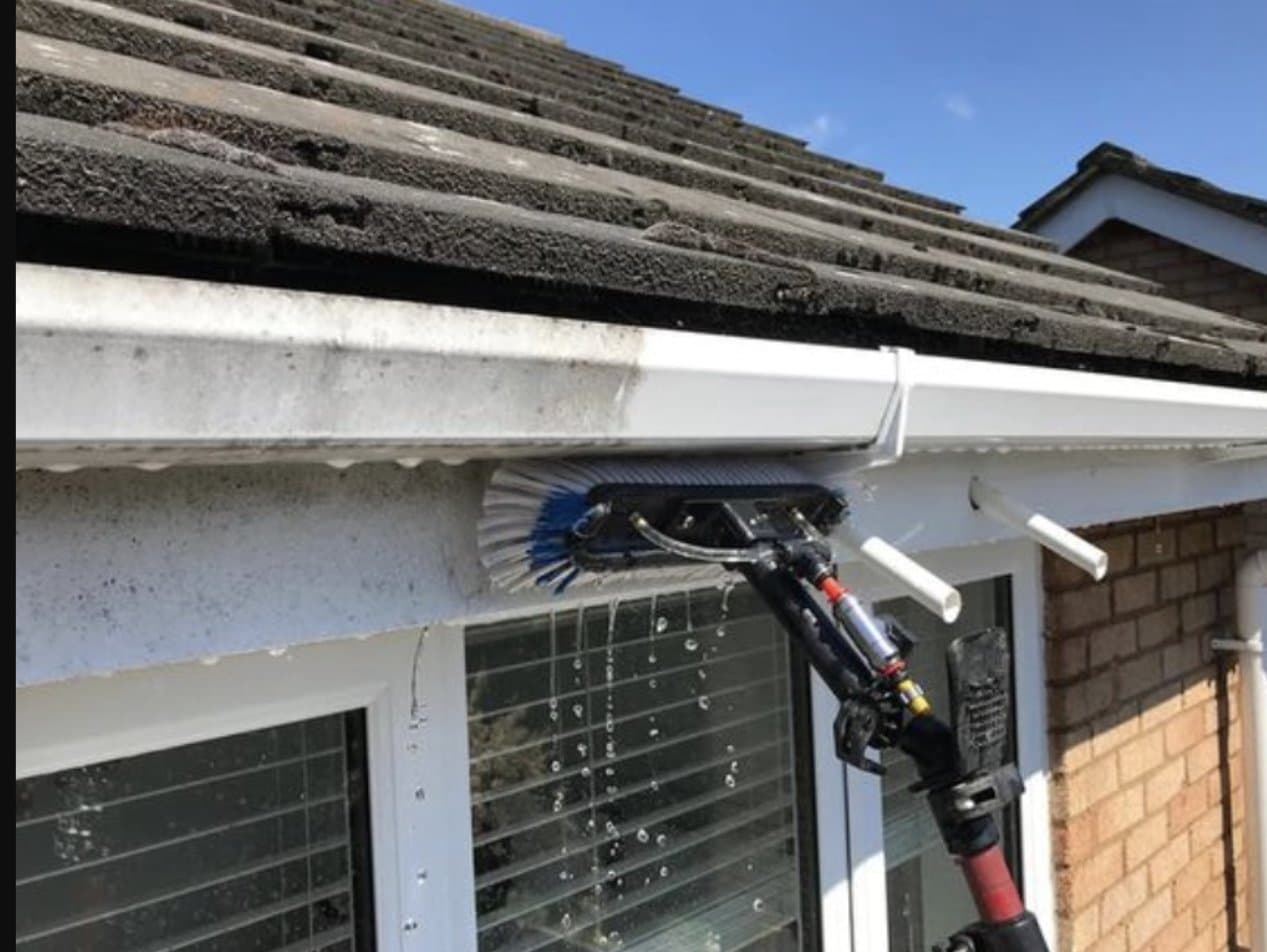 Pure-water brush cleaning a uPVC fascia and soffit