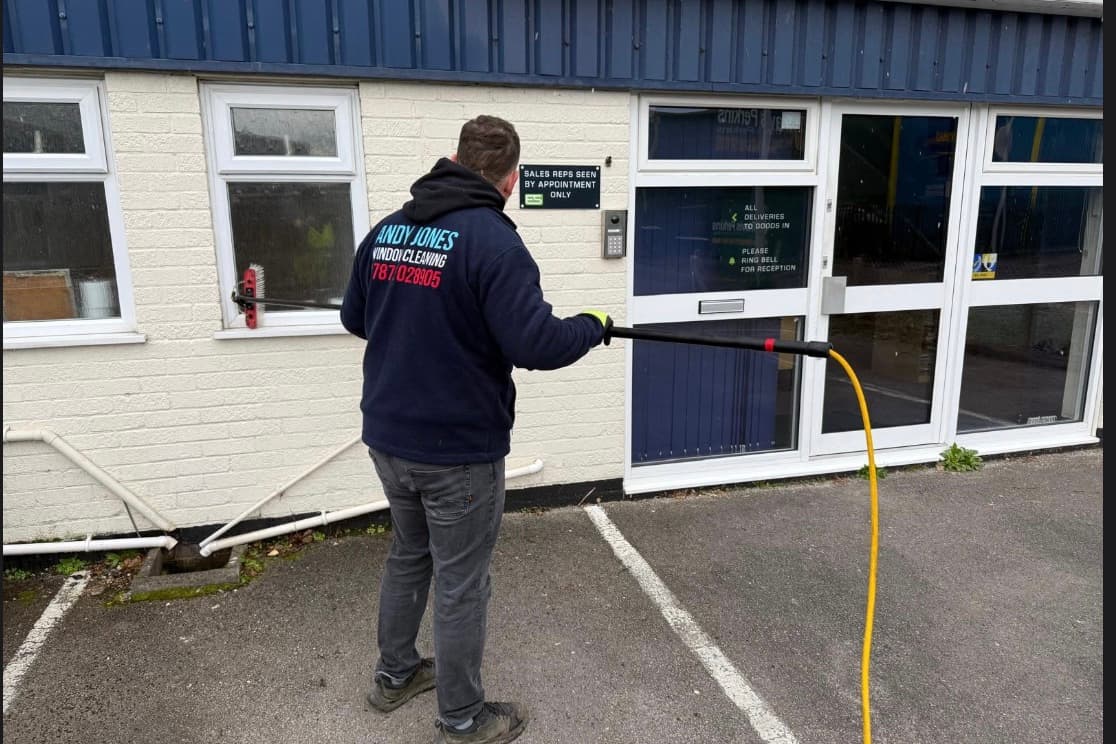 Andy Jones Window Cleaning operative cleaning a local commercial property