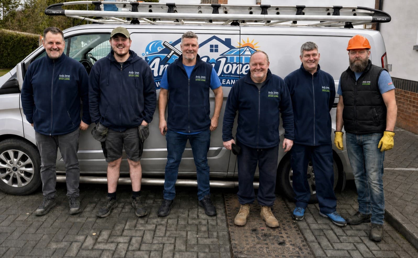 The Andy Jones Window Cleaning team who cover Theale, beside a branded van